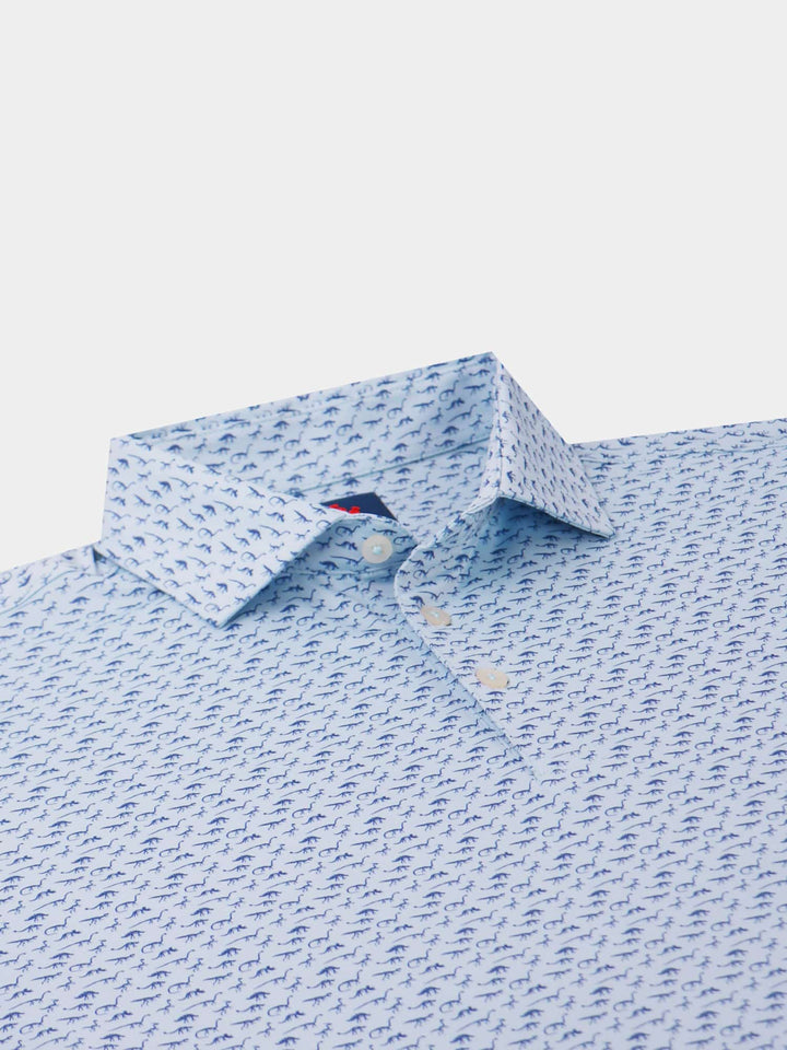 Light blue shirt with small navy dinosaur pattern, buttoned up collar, and sleek design