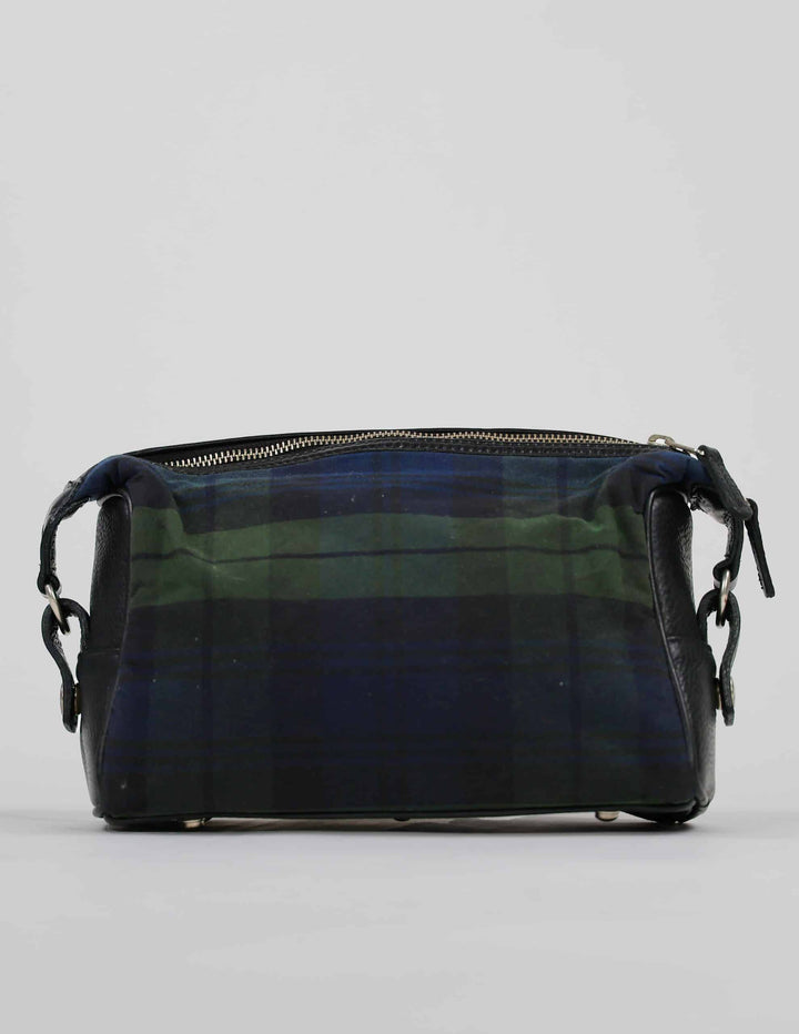 A tartan-patterned toiletry bag with green and blue checks and black leather accents
