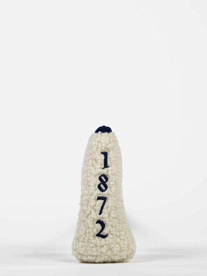 A cream-colored fabric putter cover with the numbers "1872" embroidered vertically in dark blue