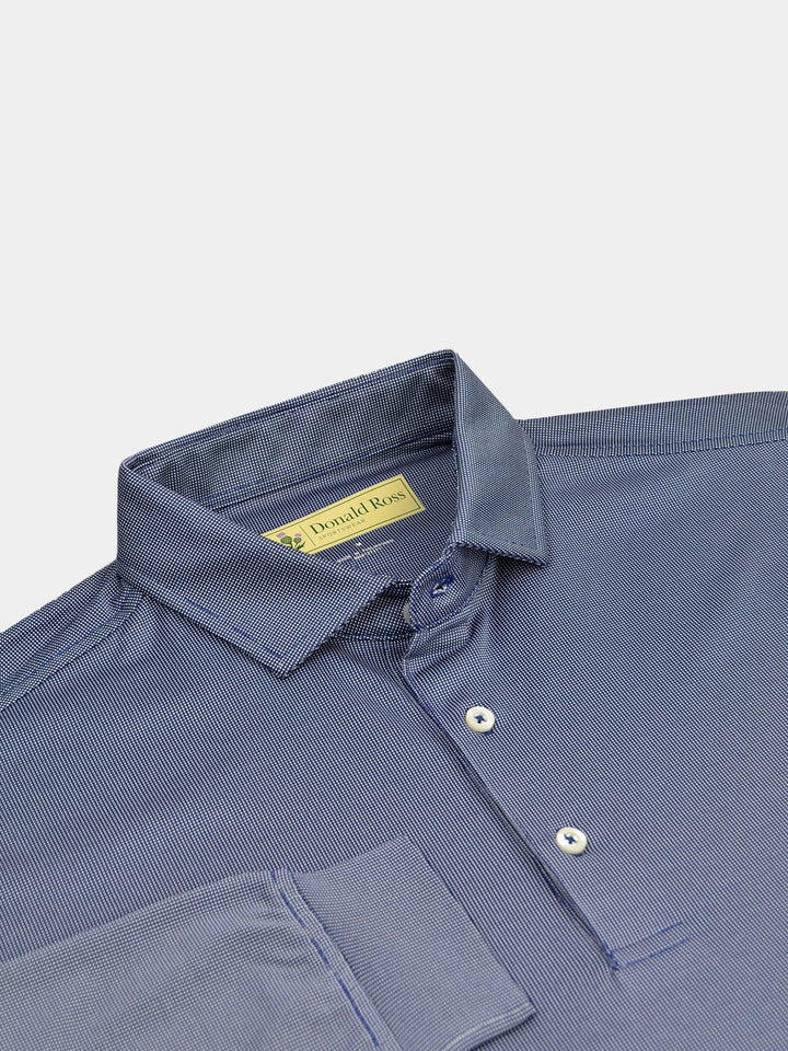 Long sleeve performance golf polo in show against a plain background