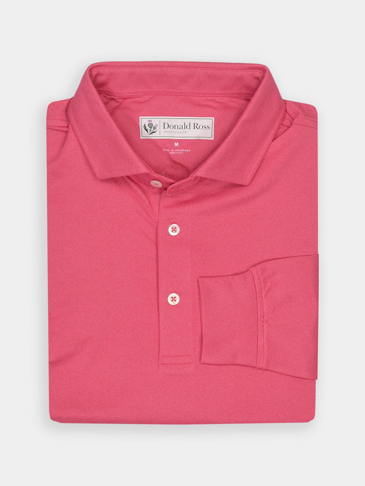 Folded pink polo shirt with a collar and three buttons