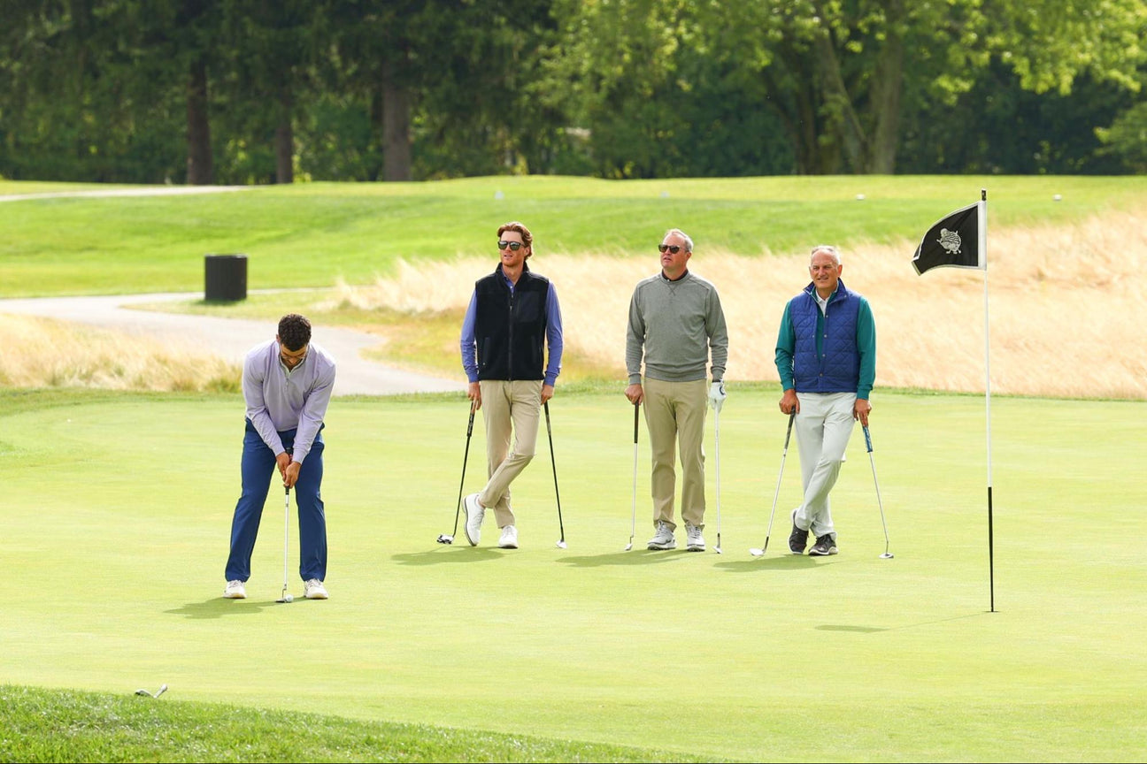 Men wearing cold weather golf wear golfing