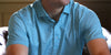 Man wearing a light blue short-sleeve polo shirt with a subtle grid pattern.