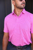 Man wearing a bright pink and white striped short-sleeve polo shirt with a collar and button placket.