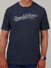 A person wearing a navy blue T-shirt with "Donald Ross Est. 1872" in white script font. The tone is casual and straightforward.