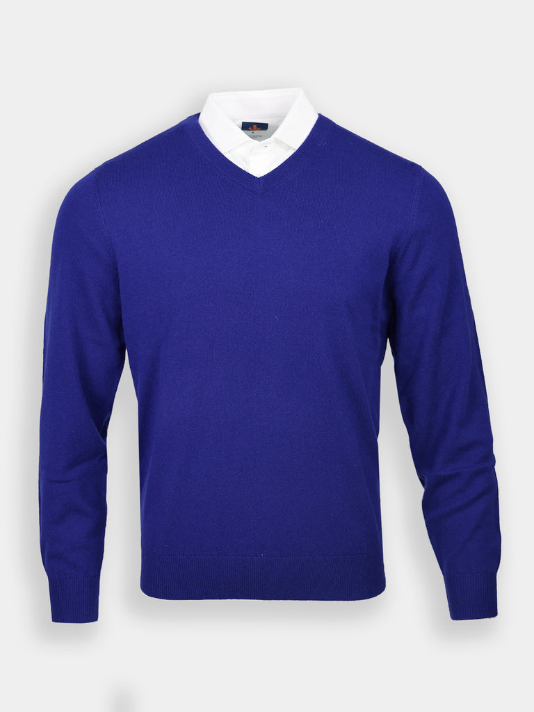 Royal blue V-neck sweater overlaying a white collared shirt, set against a light gray background. The sweater exudes a classic and elegant style.