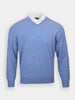 Light blue V-neck sweater over a white collared shirt. The sweater has long sleeves and a ribbed hem, conveying a smart, casual style against a plain background.
