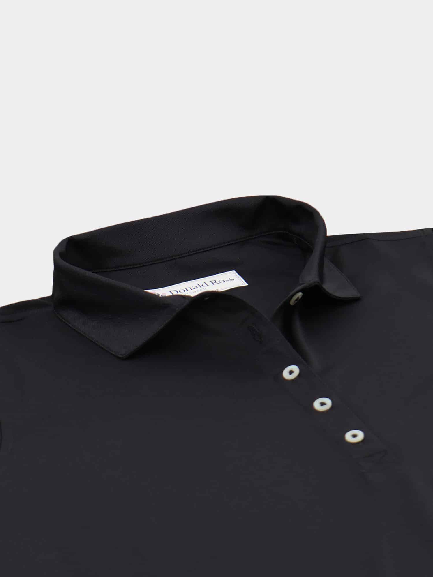 Close-up of a black dress shirt with a classic collar and white buttons