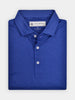 A neatly folded royal blue polo shirt with a collar and buttoned placket