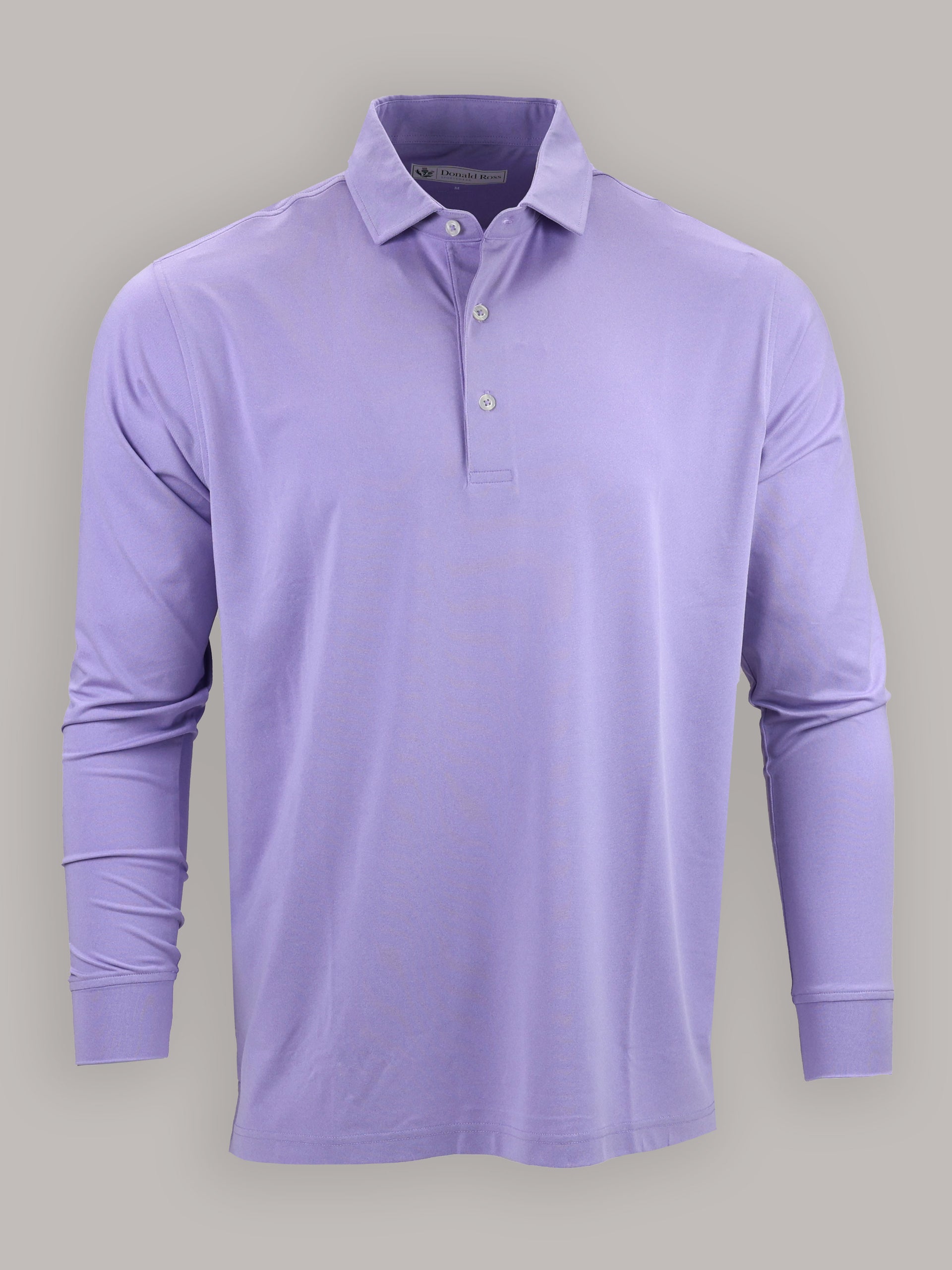 A long-sleeved, lavender polo shirt with buttons on the collar is centered on a gray background, conveying a calm and casual tone.