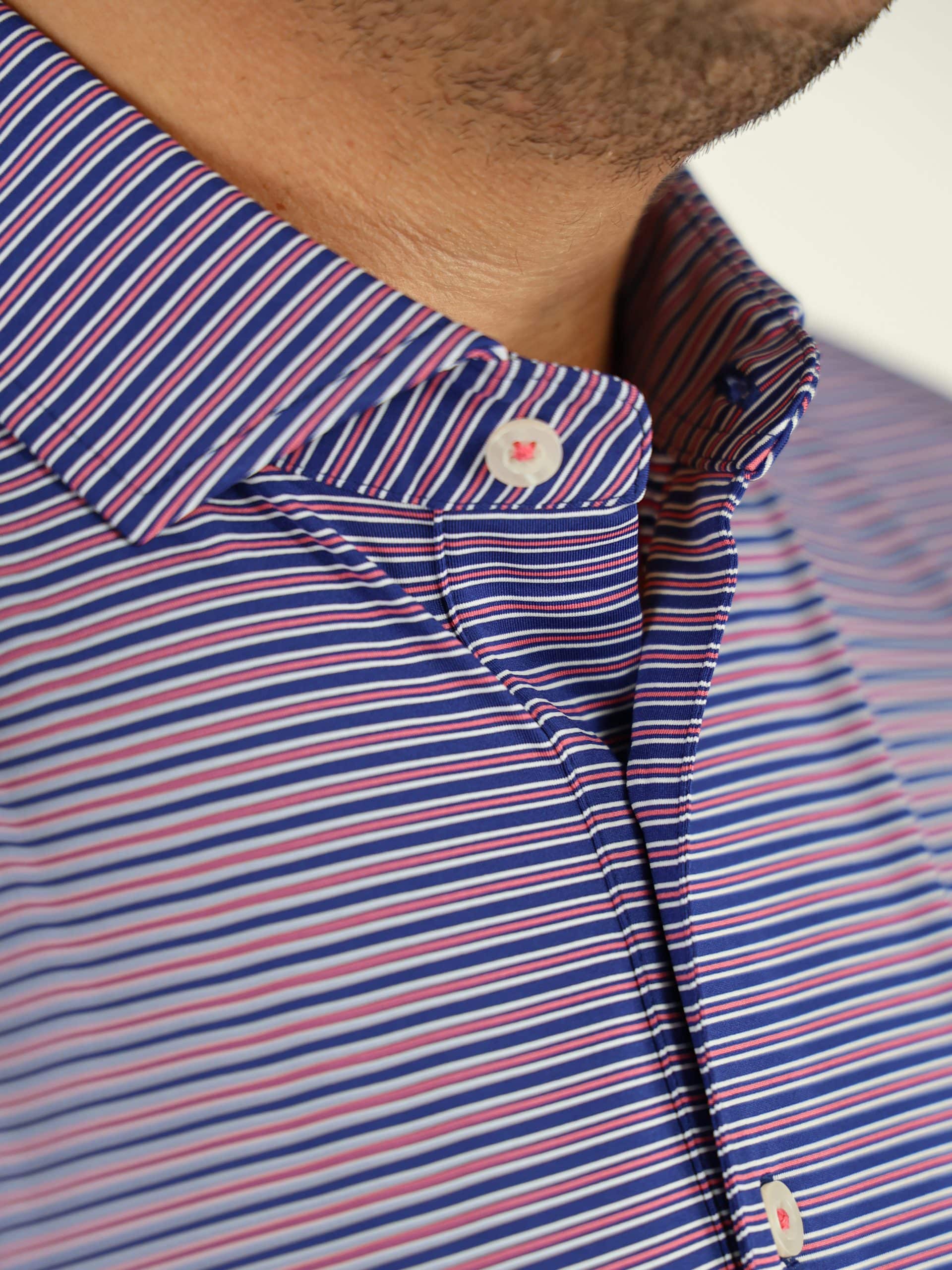 Close-up of a blue striped men's golf shirt with red and white lines