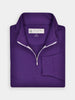A neatly folded purple half-zip pullover golf sweater with a label inside the collar. Made with a special blend of performance fabric.