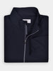 Folded black wind shell jacket with a standing collar, perfect for layering on windy days