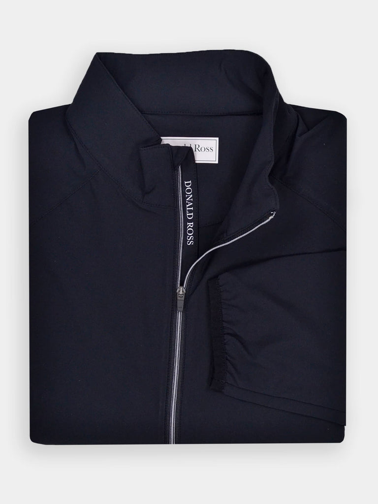 Folded black wind shell jacket with a standing collar, perfect for layering on windy days