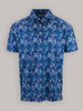 Blue floral short-sleeve shirt with a collar, featuring a vibrant pattern of pink and teal flowers. The style is casual and lively.