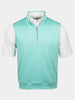A white collared shirt layered under a sleeveless, light teal 1/4 zip-up golf vest