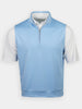 Light blue sleeveless pullover over a white short-sleeve golf shirt. The pullover has a quarter zip and a stand-up collar.