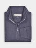 Light gray golf quarter-zip sweater neatly folded on a light surface. The sweater features ribbed cuffs and a label at the collar, exuding a casual, elegant feel.