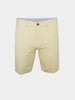 Beige performance golf shorts with a single button and zipper closure. Features belt loops and a smooth, tailored look, set against a plain white background.