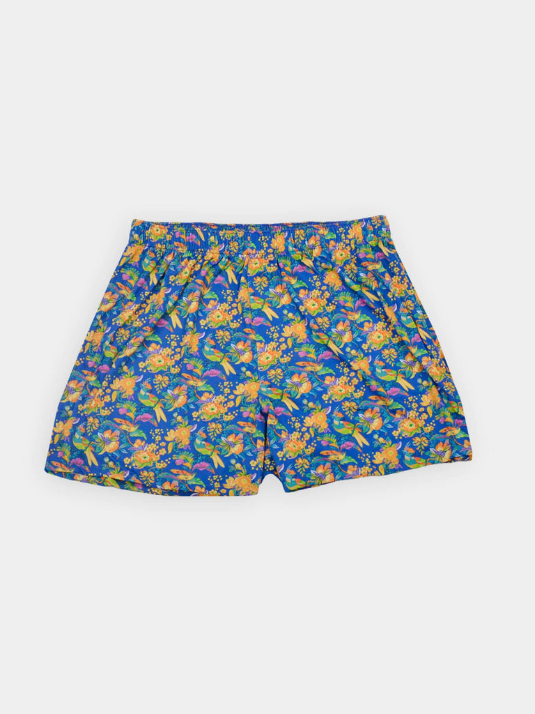 Blue boxer shorts with a vibrant floral pattern featuring yellow, orange, and purple flowers
