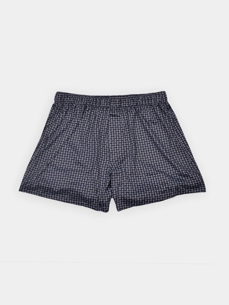 Dark blue scallop paisley men's boxer shorts with an elastic waistband, laid flat on a plain white background