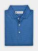 Folded blue patterned polo shirt with small geo print shapes. The shirt has a crisp collar, three shiny buttons, and a tag visible inside the neckline.