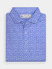 Blue floral patterned polo shirt folded neatly, featuring a subtle, intricate design. The shirt has a collared neck and button closure, conveying elegance.