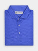 A folded blue Donald Ross polo shirt with a white peppers pattern. The shirt has three white buttons and a label at the collar, creating a crisp, stylish look.