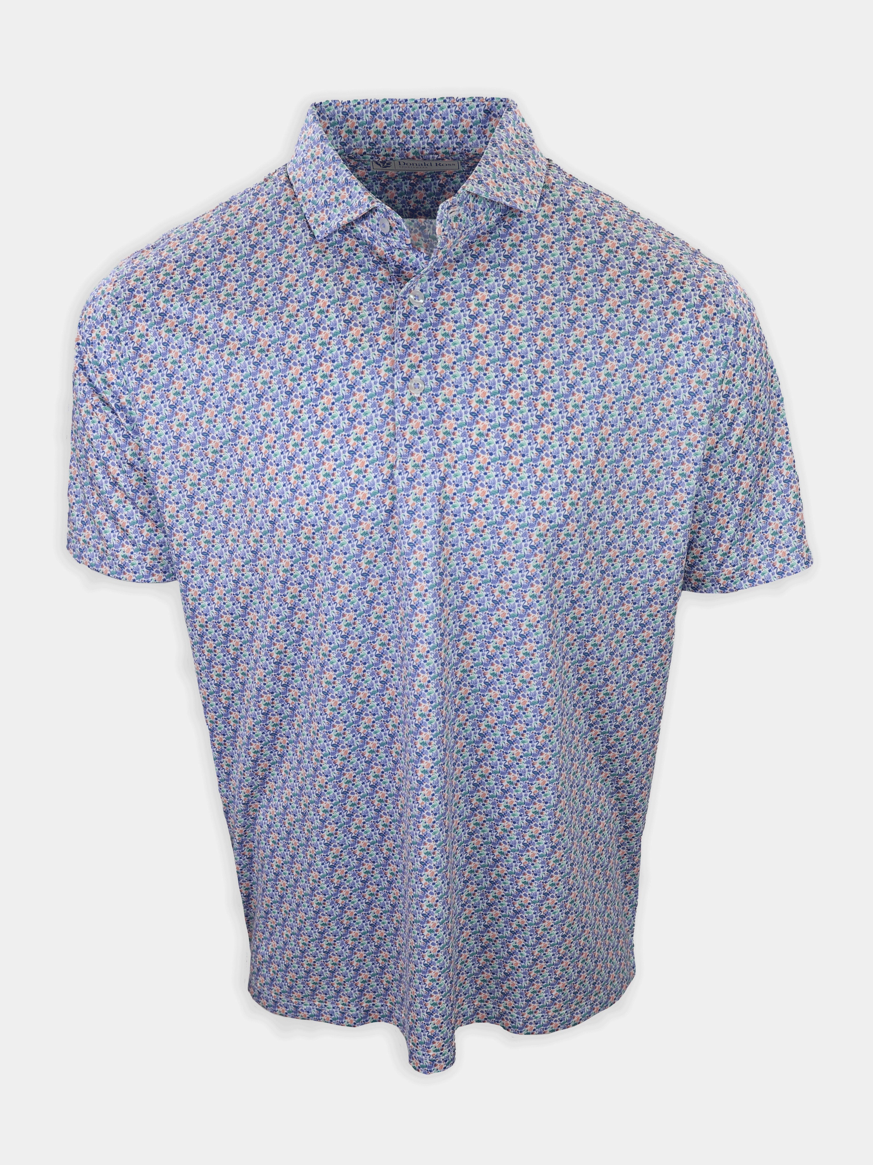 A short-sleeved shirt with a floral pattern in shades of blue, pink, and green is displayed against a plain white background.