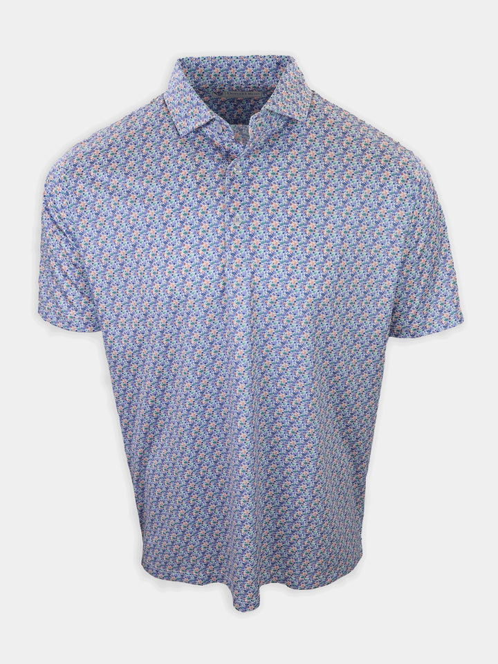 A short-sleeved shirt with a floral pattern in shades of blue, pink, and green is displayed against a plain white background.