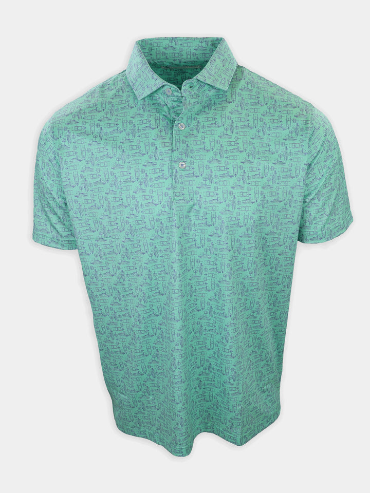 A short-sleeve polo shirt in a teal color with a repeated pattern of small boat illustrations is displayed.