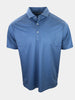 A blue polo shirt with a pattern of small green shapes is displayed.