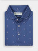 Folded blue polo shirt with small white Donald Ross logos, featuring a label with branding inside the collar