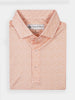 Orange and white vine-patterned polo shirt neatly folded, featuring a classic collar and three buttons