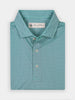 Folded teal polo shirt with a small geometric pattern and three buttons. Includes an official Donald Ross label. The fabric looks smooth and casual.
