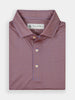 Folded polo shirt in a detailed pattern of small interlocking geometric shapes in a mix of red and blue hues