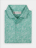 Light blue polo shirt with a subtle white floral pattern, styled with a crisp collar