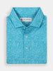 Folded blue polo shirt with a vibrant floral pattern. The fabric features intricate leaves and flowers, evoking a fresh and cheerful tone.