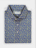 Folded blue shirt with a vibrant yellow floral pattern. White buttons adorn the front, with a Donald Ross Sportswear logo