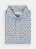Folded patterned golf polo shirt with blue and green sunglasses. Collar is neatly arranged, conveying a polished look.