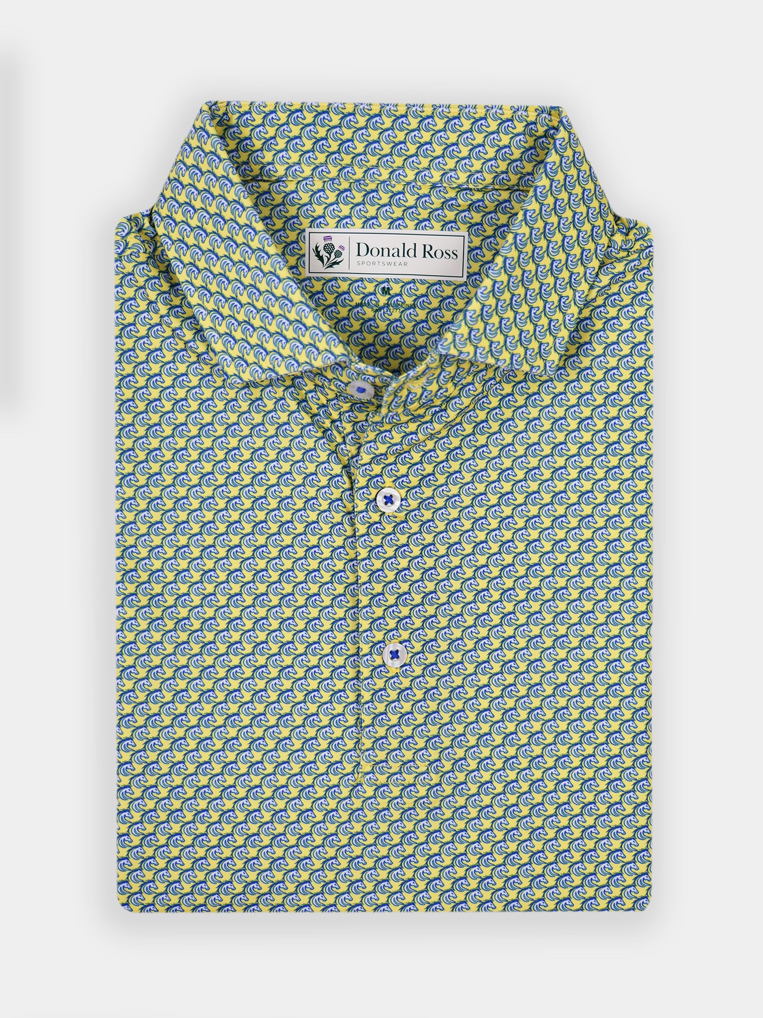Folded short-sleeve shirt with a vibrant yellow and blue stallio print pattern