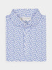 Folded white shirt with small blue floral pattern, neatly arranged. The shirt has buttons and a label at the collar, conveying a clean, fresh look.