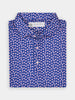 Folded blue floral-patterned polo shirt with pink and white flowers, neatly arranged on a white background