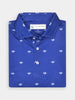 Folded blue polo shirt with small white Donald Ross logos evenly patterned. It has white buttons and a visible tag inside the collar.