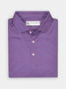Folded, purple Donald Ross polo shirt with a subtle geometric pattern. Features a classic collar and pink buttons, conveying a stylish, casual tone.