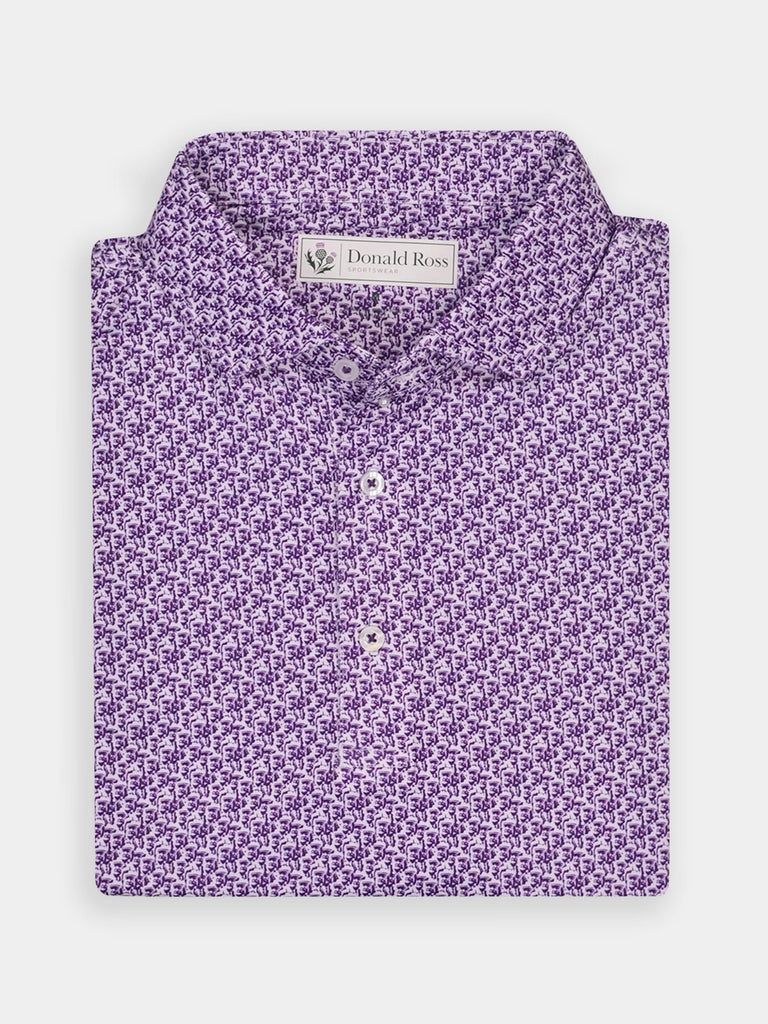 Folded purple polo shirt with intricate floral pattern. Features buttons down the front and a visible label at the collar, giving a sophisticated look.