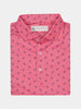 A folded pink polo shirt with a subtle pattern of small blue dodos. The collar is neatly arranged, and three buttons are visible down the front.