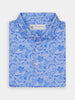 Blue paisley-patterned button-up shirt neatly folded against a white background, featuring intricate white swirls and a tag at the collar.