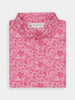 Folded pink paisley shirt with a white and pink pattern, featuring a collar and buttons, set against a white background. The design conveys a vibrant, stylish tone.