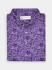 Folded purple paisley patterned shirt with a spread collar and white buttons, conveying an elegant and sophisticated style.